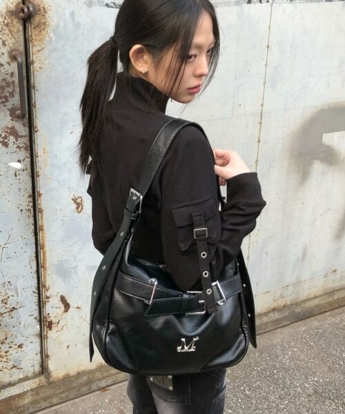 MUCENT MONIC METAL LOGO FRONT BELTED LEATHER SHOULDER BAG